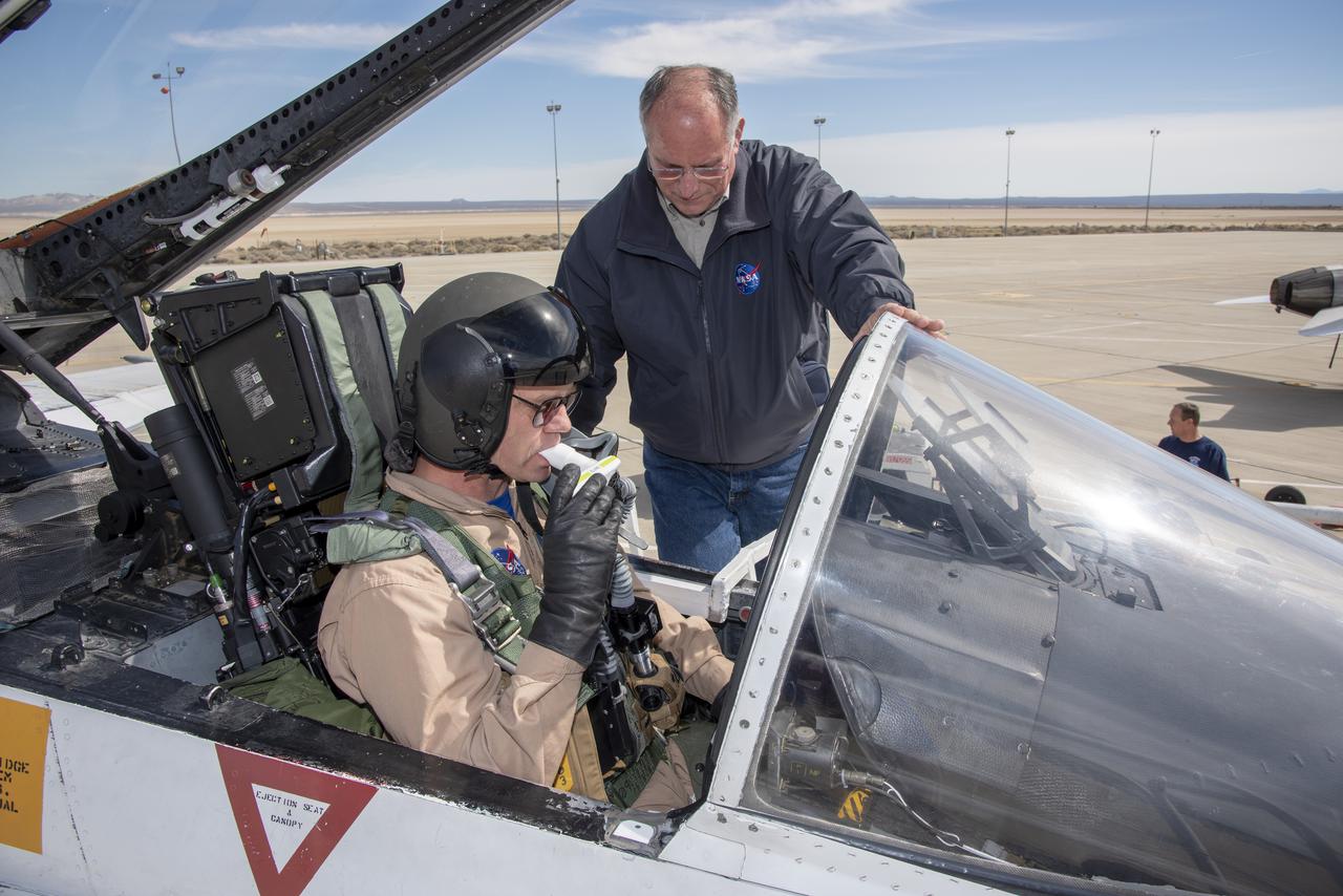 Phillip Wellner from Life Support conducts a spirometry test on NASA Pilot Nils Larson before a Pilot Breathing Assessment flight at NASAâ€™s Armstrong Flight Research Center in California.Â 