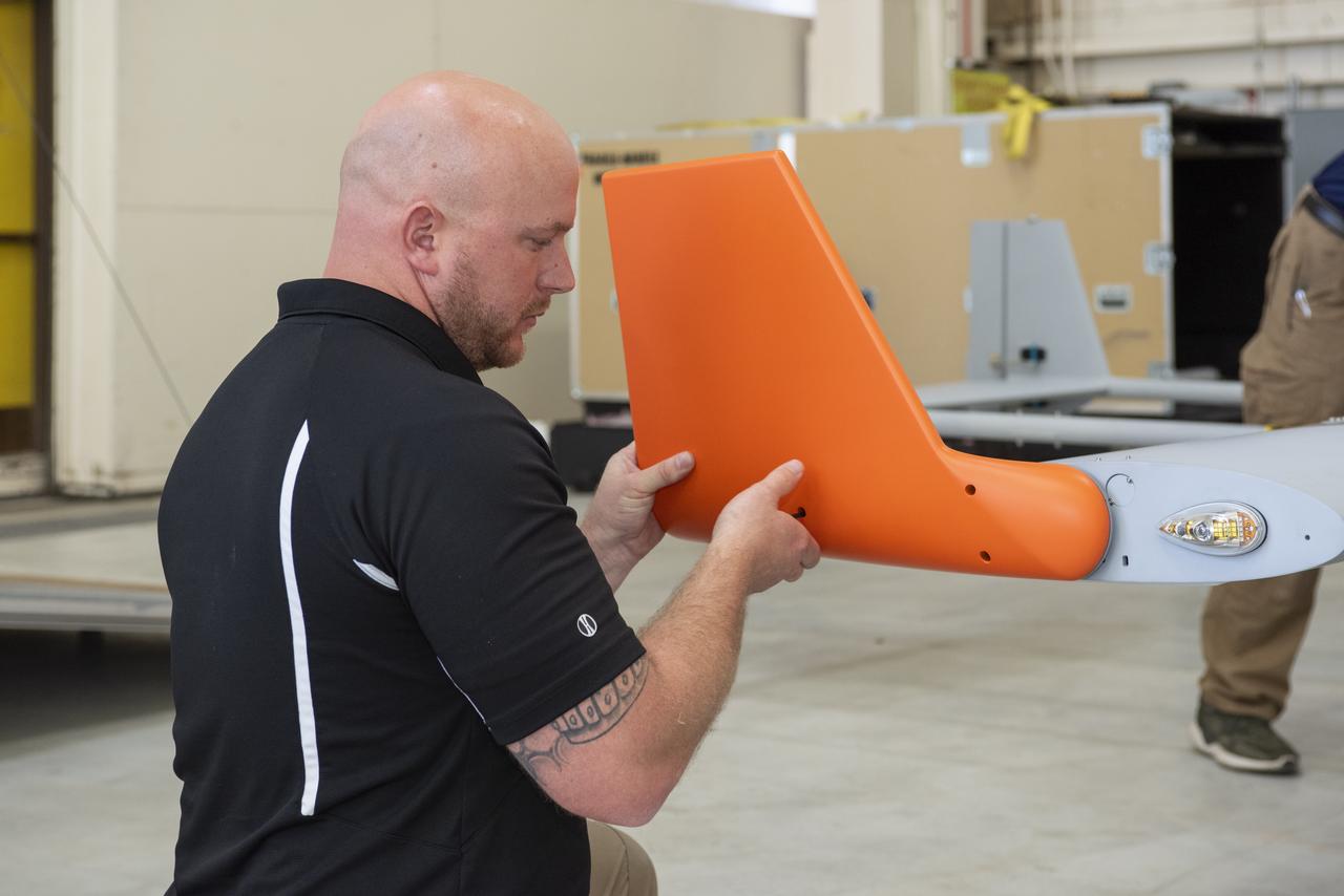 Brad Petty from Navmar Applied Sciences Corporation attaches a winglet to the TigerShark upon arrival at NASA Armstrong Flight Research Center. 