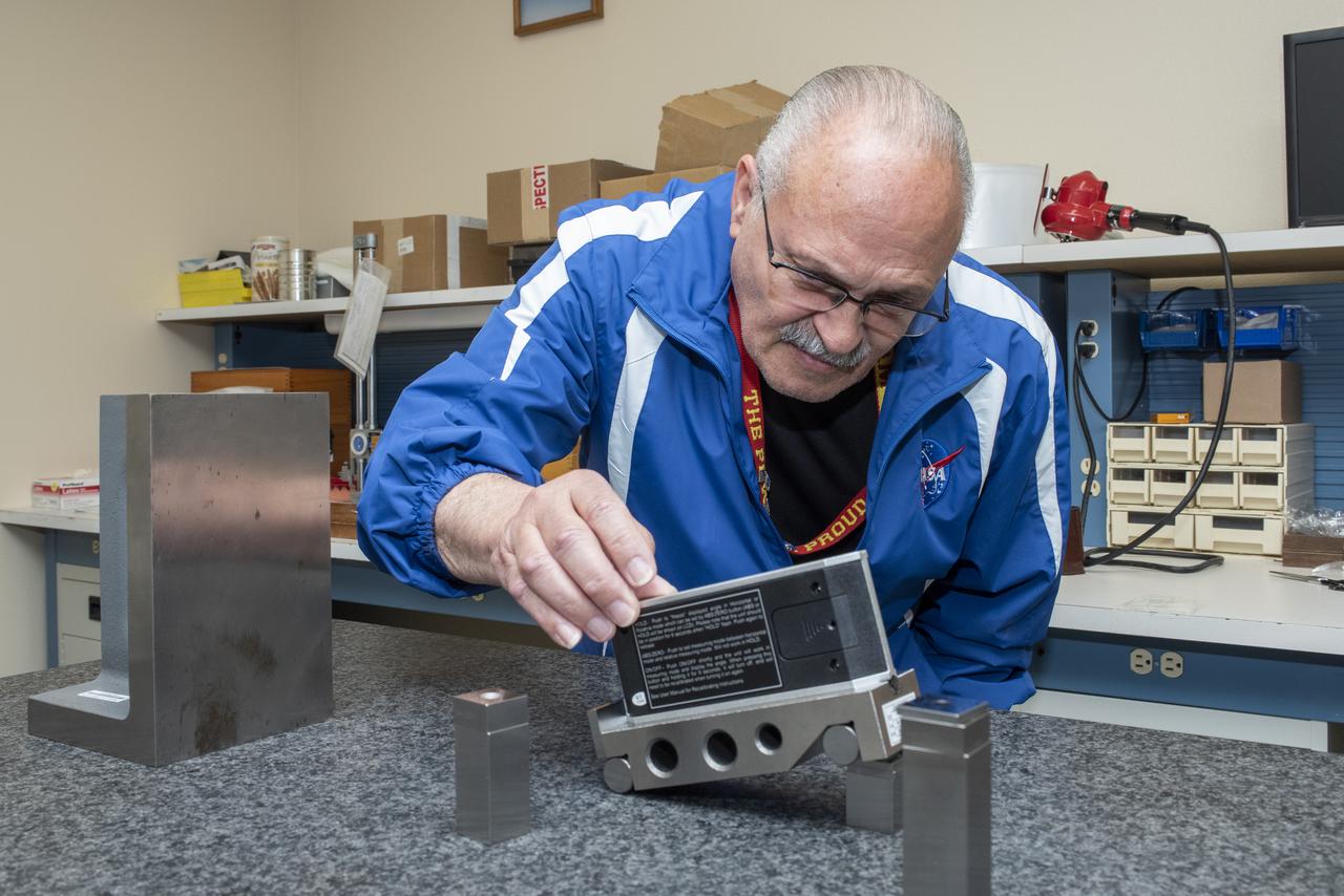 Arnold Gonzales, a 20-year veteran of the NASA Armstrong Calibration Laboratory, uses a digital protractor to calibrate an item sent to the lab at NASA’s Armstrong Flight Research Center in California.