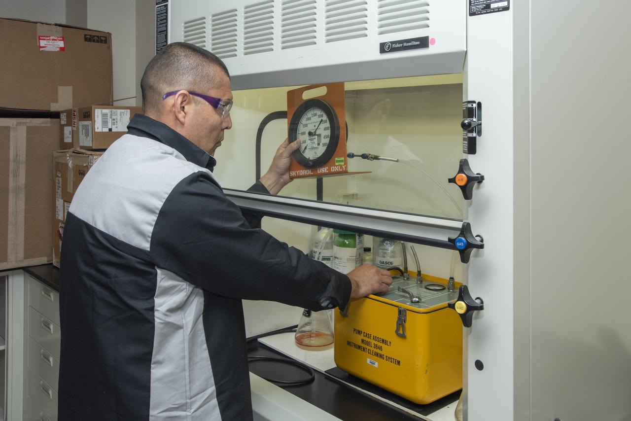 Alex Rivera purges a gauge of contamination prior to a calibration test at NASA's Armstrong Flight Research Center in California.