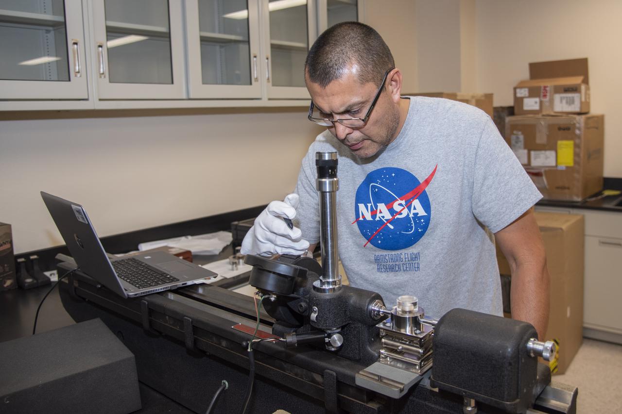 Alex Rivera calibrates a cylindrical plug gauge at NASA's Armstrong Flight Research Center Calibration Laboratory in California.