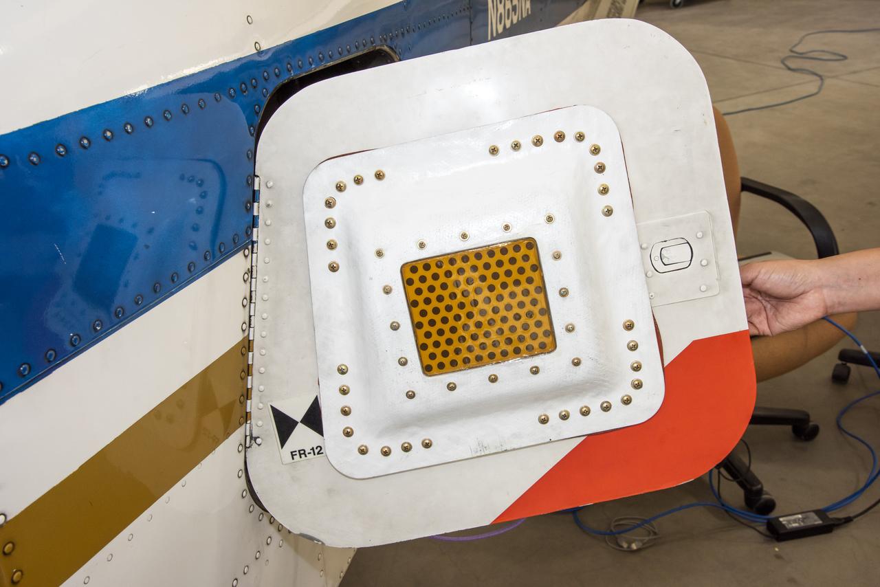 A photo of the conformal antenna installed on the door of T-34C aircraft. The conformal antenna was developed and designed by members of the Conformal Lightweight Antenna Structures for Aeronautical Communications Technologies activity within the Convergent Aeronautics Solutions project. The antenna is made of aerogels which have resulted in a thin, flexible antenna substrate with improved gain, bandwidth and efficiency.