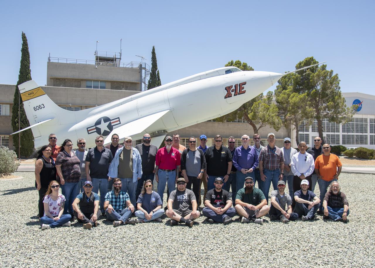 The Dryden Aeronautical Test Range staff at NASA’s Armstrong Flight Research Center in California monitor all aircraft flights from the center as well as supporting the International Space Station and Russian Soyuz missions. Sitting from left to right are Bailey Cook, Lucio Ortiz, Matt Kearns, Sonja Belcher, John Batchelor, Jeff Koenig, Will Peters, Russ Franz, Zack Springer and Mike Webb. Standing left to right are Joy Bland, Doug Boston, April Norcross, Randy Torres, Robert Racicot, Jesus Vazquez, Jim Abercromby, Steve Simison, Tracy Ackeret, Chris Birkinbine, Darryl Burkes, Joe Innis, Bruce Lipe, Pat Ray, Kevin Knutson, Greg Strombo, Bart Rusnak, Tim Burt, Al Guajardo, Feras, Abu-Issa and Hector Rodriquez.