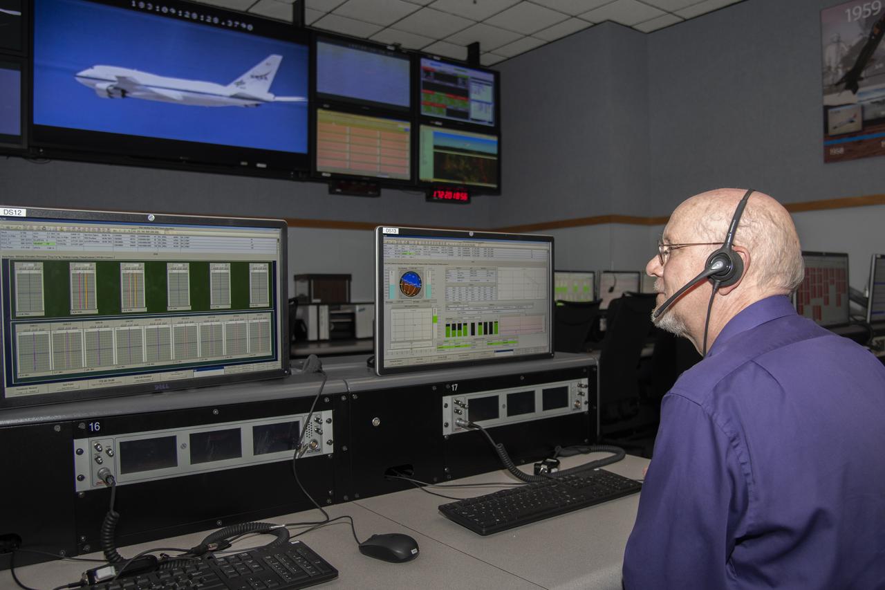 Kevin Knutson sits at a station in the main Blue Control Room at NASA’s Armstrong Flight Research Center in California used during complex flight missions to house the many technical discipline experts required to gather all of the required data and to enhance mission safety.