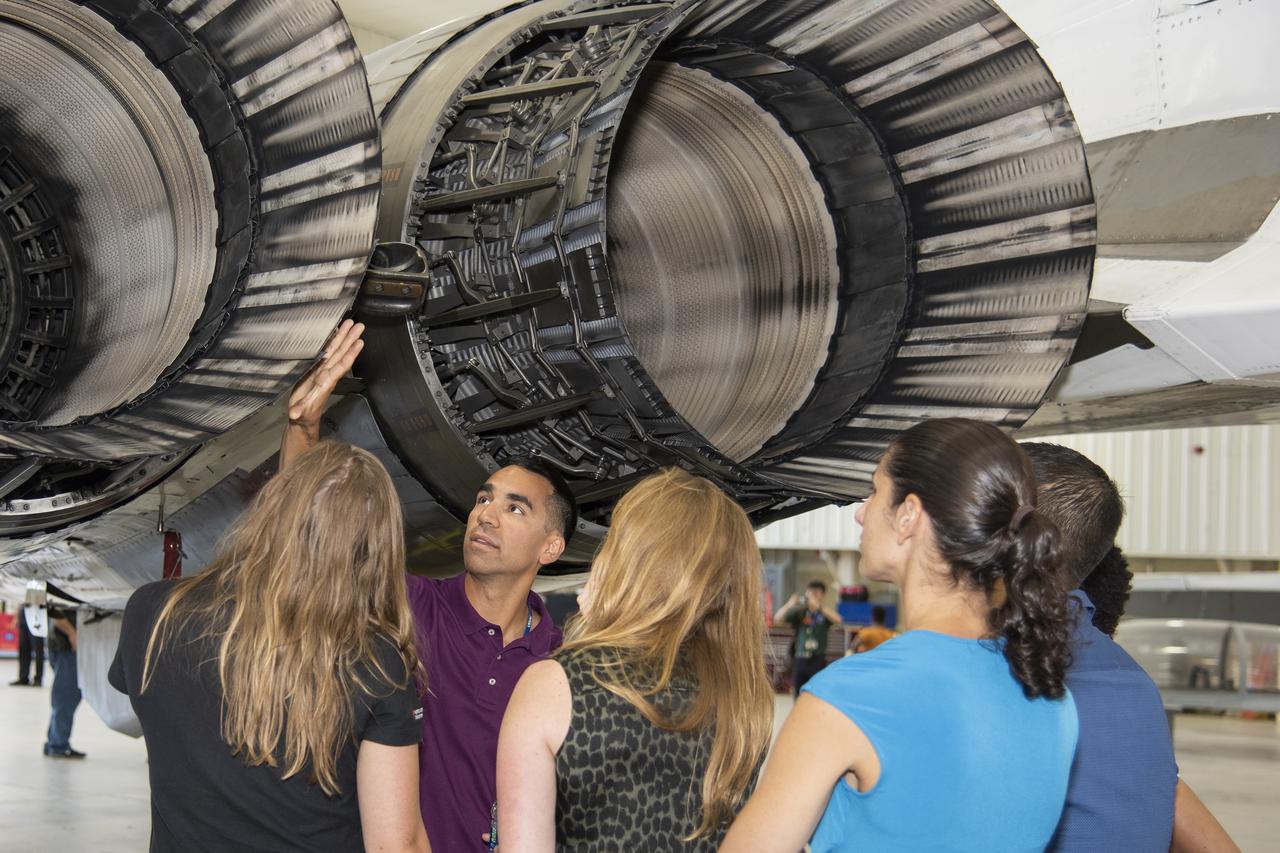 NASA's 2017 astronaut candidates toured aircraft hangar at Armstrong Flight Research Center, in Southern California (L to R) Jenni Sidey-Gibbons, Raja Chari, Loral O'Hara, Jasmin Moghbeli, Jonny Kim and Jessica Watkins look inside the engine nozzle of an F-15 jet.  The F-15 will fly in tandem with the X-59 QueSST during early flight test stages for the X-59 development.