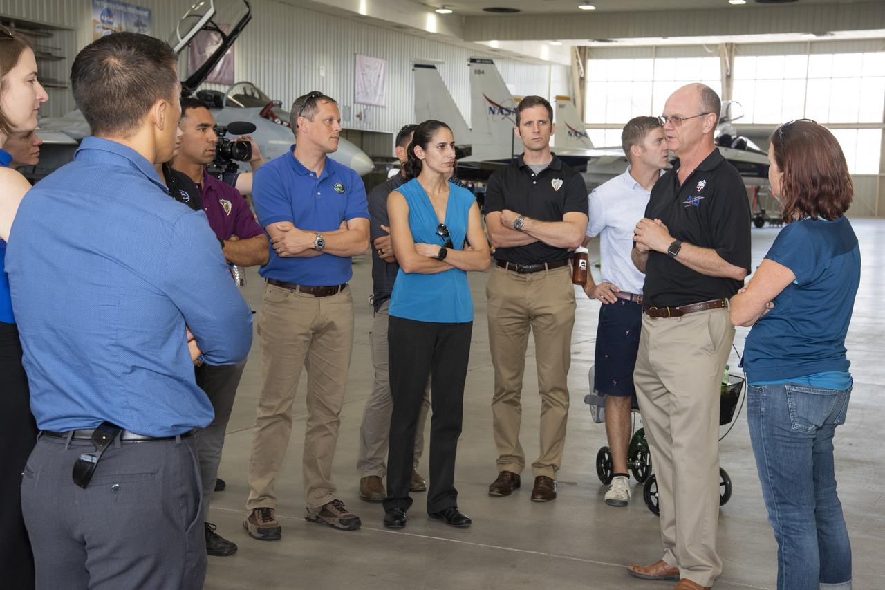 NASA’s 2017 astronaut candidates toured aircraft hangar at Armstrong Flight Research Center, in Southern California. On the right, NASA’s, X-59 pilot Nils Larsen, briefs the astronauts as they look at Armstrong’s fleet of supersonic research support aircraft, including the F-15, which will fly in tandem with the X-59 QueSST during early flight test stages, and the F-18, which is conducting supersonic research in support of the overall mission.