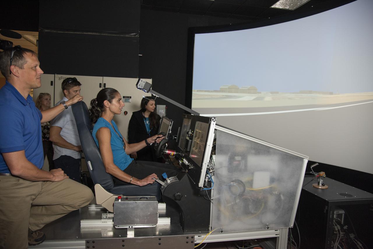 NASA's 2017 astronaut candidates (L to R) Bob Hines, Matthew Dominick and Jasmin Moghbeli practice flying in X-57 aircraft simulator at Armstrong Flight Research Center in Southern California. Starting with the fuselage of a Tecnam P20067T, the X-57 Maxwell electric propulsion airplane is being built from ideas being researched that could lead to the development of electric propulsion-powered aircraft, which would be quieter, more efficient and environmentally friendly than today's commuter aircraft.