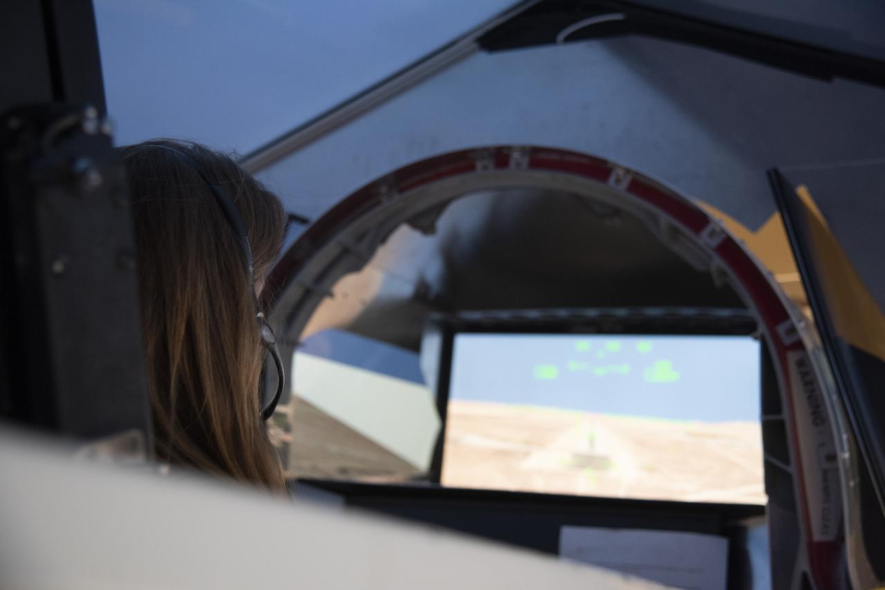 NASA's 2017 astronaut candidate Kayla Barron practices flying in an X-59 QueSST simulator at Armstrong Flight Research Center, in Southern California. The low boom flight demonstrator, X-59, being built at Lockheed Martin and was designed to fly at supersonic speeds over land without the loud noise of breaking the sound barrier and disturbing communities.