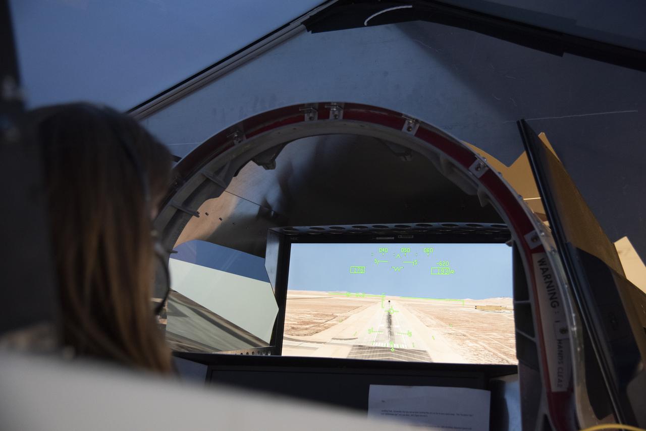 NASA's 2017 astronaut candidate Kayla Barron practices flying in an X-59 QueSST simulator at Armstrong Flight Research Center, in Southern California. The low boom flight demonstrator, X-59, being built at Lockheed Martin and was designed to fly at supersonic speeds over land without the loud noise of breaking the sound barrier and disturbing communities.