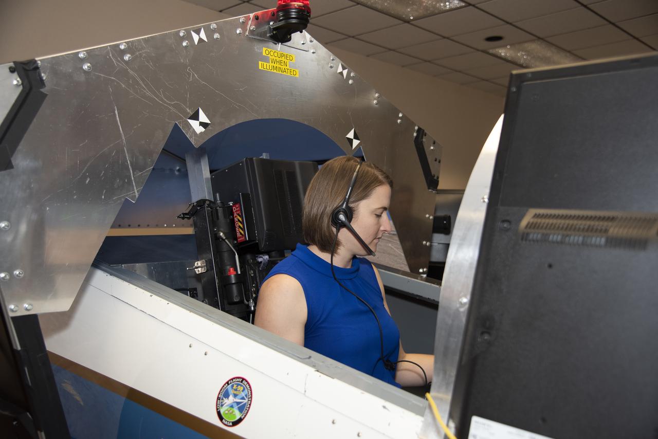 NASA's 2017 astronaut candidate Kayla Barron practices flying in an X-59 QueSST simulator at Armstrong Flight Research Center, in Southern California. The low boom flight demonstrator, X-59, being built at Lockheed Martin and was designed to fly at supersonic speeds over land without the loud noise of breaking the sound barrier and disturbing communities.