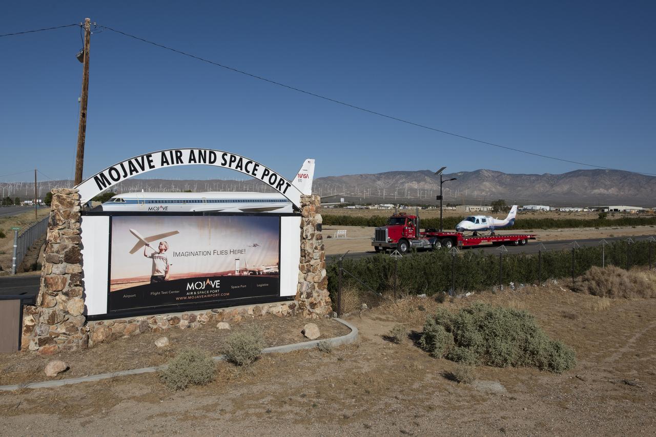 NASA’s all-electric X-57 Maxwell, in its Mod II configuration, departs Scaled Composites’ facility at Mojave Air and Space Port, en route to NASA’s Armstrong Flight Research Center in Edwards, California for delivery. The aircraft, shipped as two parts – the fuselage and the wing – was delivered to NASA Armstrong’s Research Aircraft Integration Facility, where it will be reintegrated to begin ground tests, to be followed by taxi tests, and eventually, flight tests. X-57’s Mod II configuration, the first of three primary modifications for the project, involves testing of the aircraft’s cruise electric propulsion system. The goal of the X-57 project is to share the aircraft’s electric-propulsion-focused design and airworthiness process with regulators, to advance certification approaches for distributed electric propulsion in general aviation.