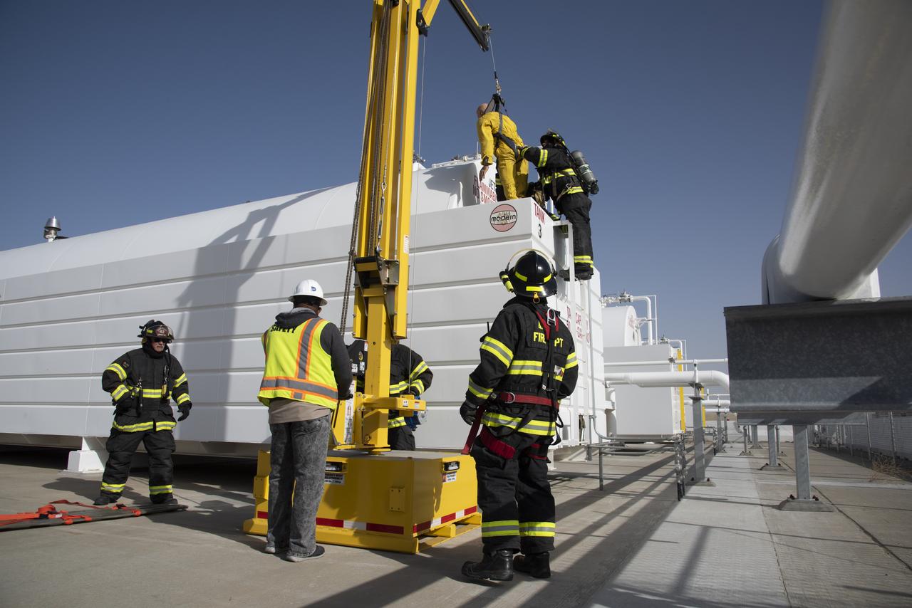 Syd Myers, a NASA Armstrong Flight Research Center confined space supervisor for a drill at NASA Armstrong Flight Research Center’s Building 703 in Palmdale, California, observes U.S. Air Force Plan 42 Fire Department responders extract a mannequin from a confined space as part of an emergency exercise.