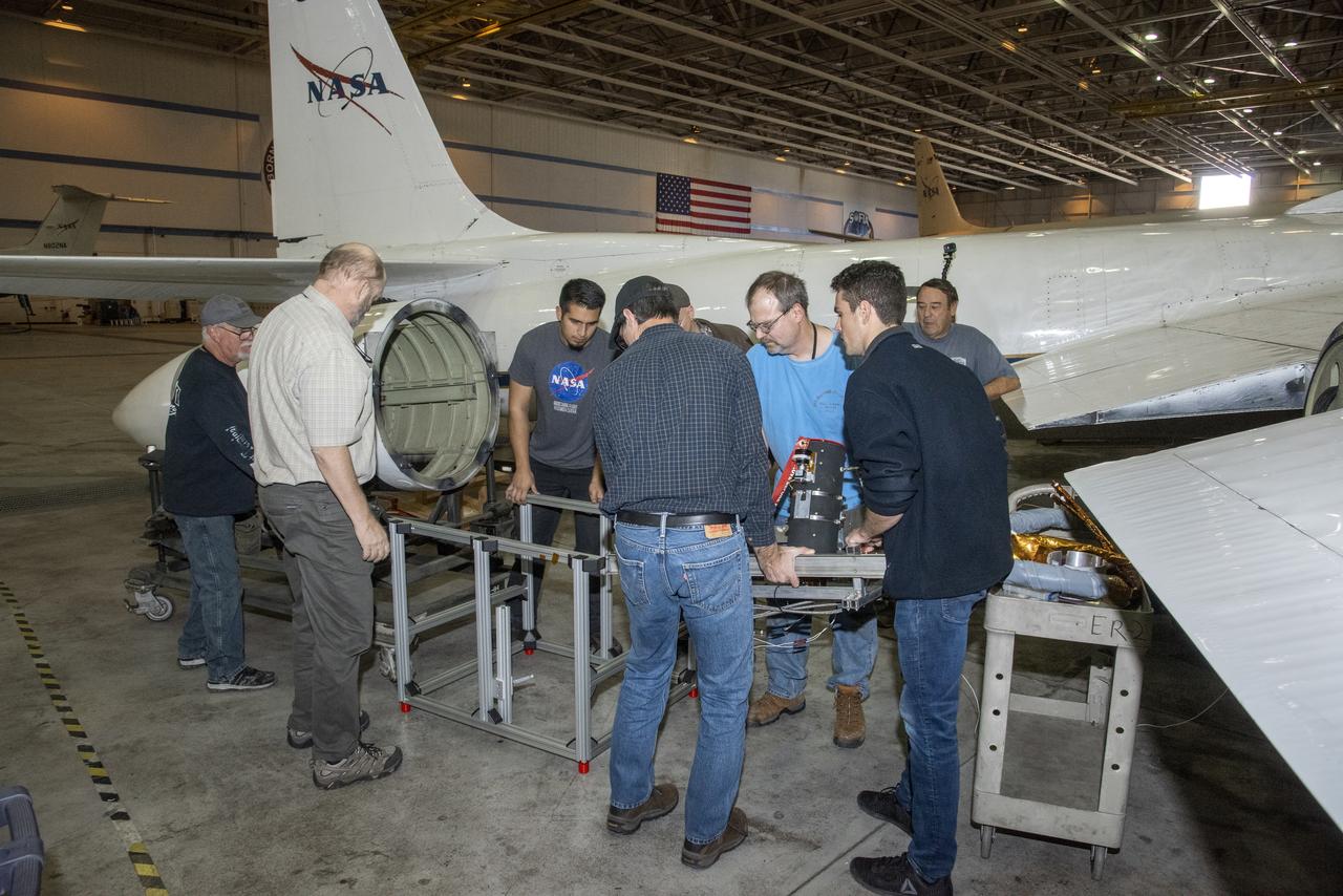 The air-LUSI crew and ground crew from NASA’s Armstrong Flight Research Center in Palmdale, CA place air-LUSI’s component from the wingpod to the stand for hangar calibration.