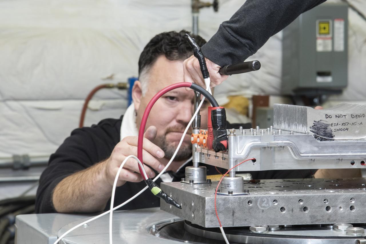 Engineers from NASA’s Armstrong Flight Research Center and Empirical Systems Aerospace prepare a cruise motor controller, planned to be used on NASA’s all-electric X-57 Maxwell, for vibration testing at Armstrong’s environmental lab. Testing the cruise motor controller at various vibration levels, based on baseline flight testing in the project’s first phase, helps ensure that the hardware will withstand similar vibration in flight conditions. X-57, NASA’s first all-electric experimental aircraft, or X-plane, will fly in its first all-electric configuration in 2020.