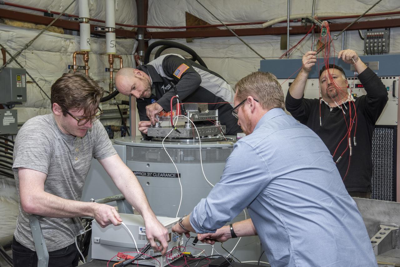 Engineers from NASA's Armstrong Flight Research Center and Empirical Systems Aerospace prepare a cruise motor controller, planned to be used on NASA's all-electric X-57 Maxwell, for vibration testing at Armstrong's environmental lab. Testing the cruise motor controller at various vibration levels, based on baseline flight testing in the project's first phase, helps ensure that the hardware will withstand similar vibration in flight conditions. X-57, NASA's first all-electric experimental aircraft, or X-plane, will fly in its first all-electric configuration in 2020.