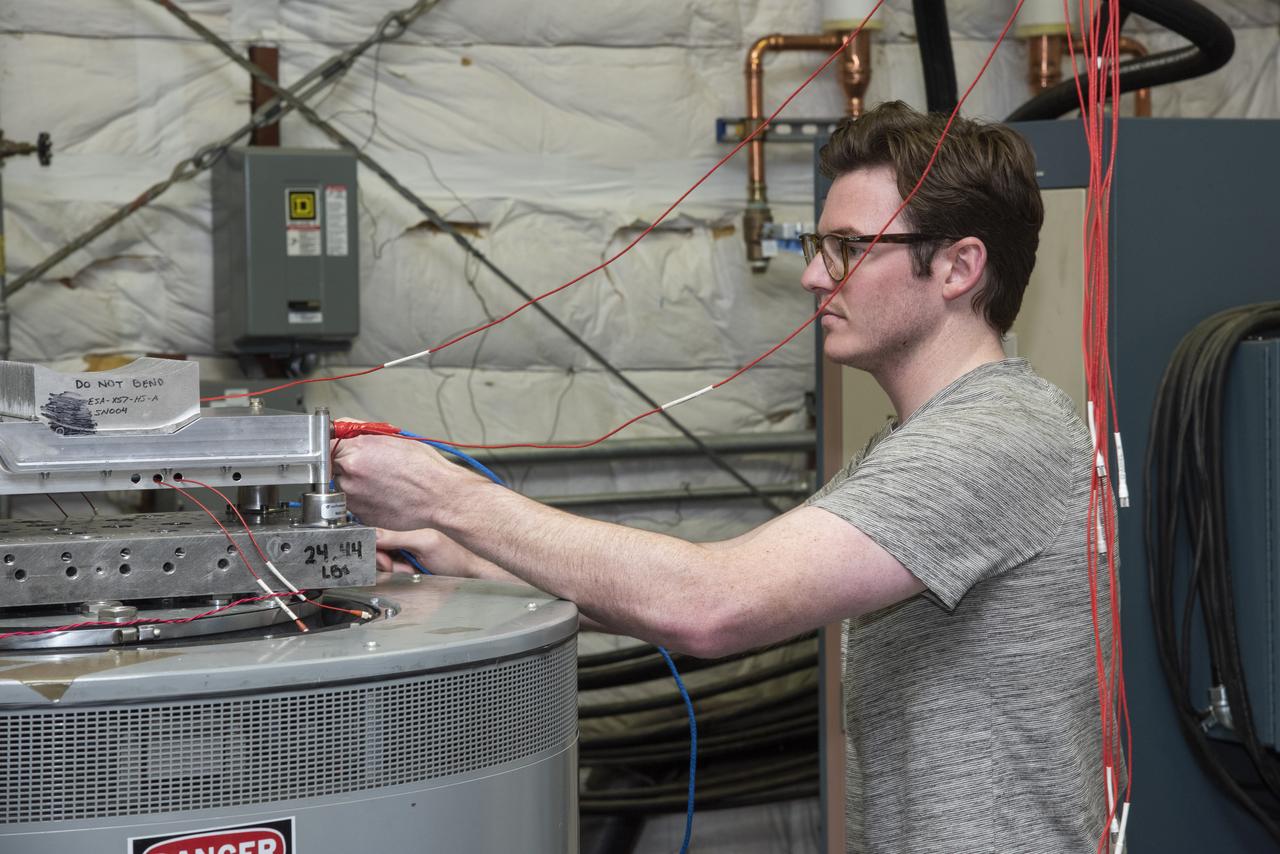 Engineers from NASA's Armstrong Flight Research Center and Empirical Systems Aerospace prepare a cruise motor controller, planned to be used on NASA's all-electric X-57 Maxwell, for vibration testing at Armstrong's environmental lab. Testing the cruise motor controller at various vibration levels, based on baseline flight testing in the project's first phase, helps ensure that the hardware will withstand similar vibration in flight conditions. X-57, NASA's first all-electric experimental aircraft, or X-plane, will fly in its first all-electric configuration in 2020.
