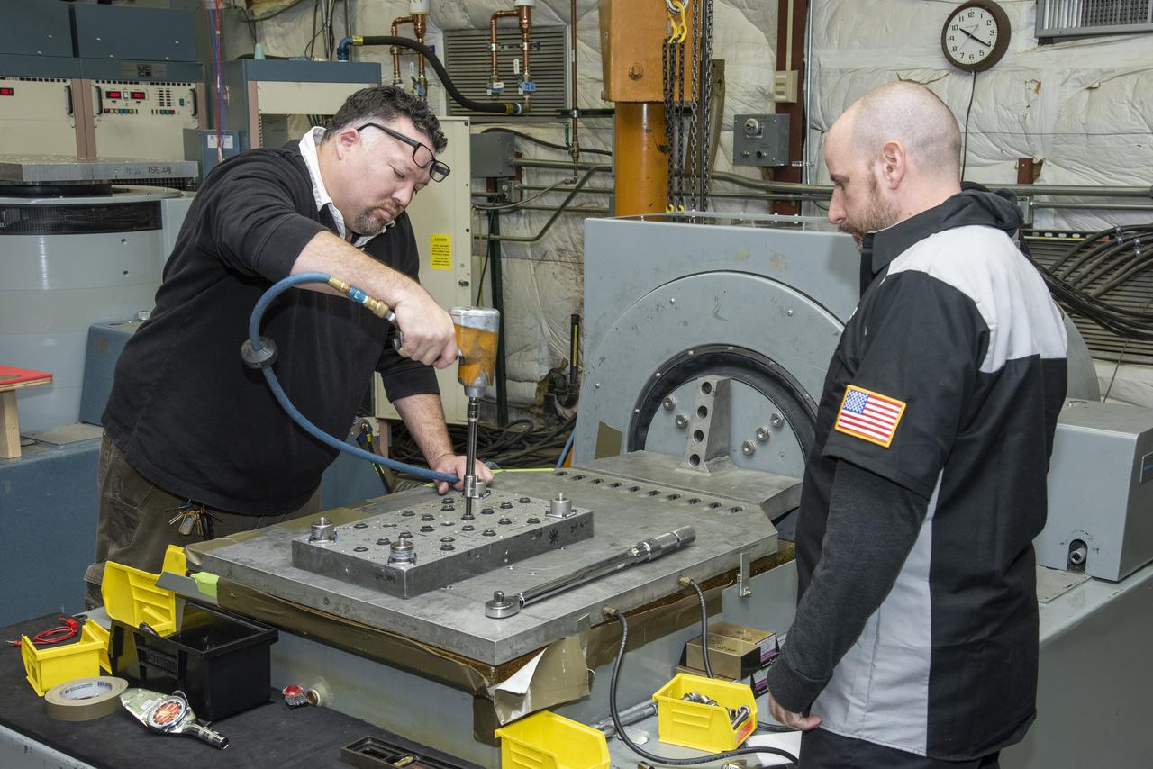 Engineers from NASA's Armstrong Flight Research Center and Empirical Systems Aerospace prepare a cruise motor controller, planned to be used on NASA's all-electric X-57 Maxwell, for vibration testing at Armstrong's environmental lab. Testing the cruise motor controller at various vibration levels, based on baseline flight testing in the project's first phase, helps ensure that the hardware will withstand similar vibration in flight conditions. X-57, NASA's first all-electric experimental aircraft, or X-plane, will fly in its first all-electric configuration in 2020.