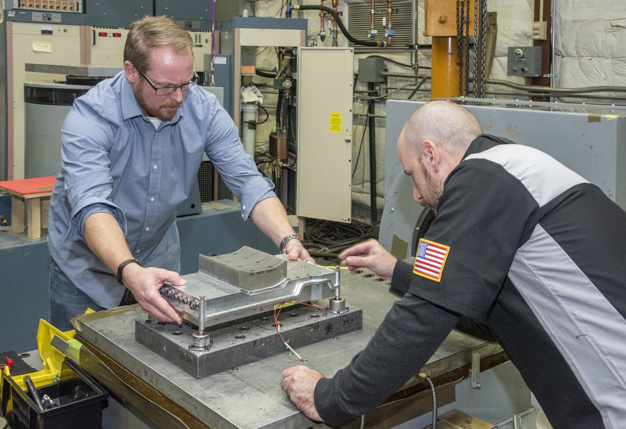 Engineers from NASA's Armstrong Flight Research Center and Empirical Systems Aerospace prepare a cruise motor controller, planned to be used on NASA's all-electric X-57 Maxwell, for vibration testing at Armstrong's environmental lab. Testing the cruise motor controller at various vibration levels, based on baseline flight testing in the project's first phase, helps ensure that the hardware will withstand similar vibration in flight conditions. X-57, NASA's first all-electric experimental aircraft, or X-plane, will fly in its first all-electric configuration in 2020.