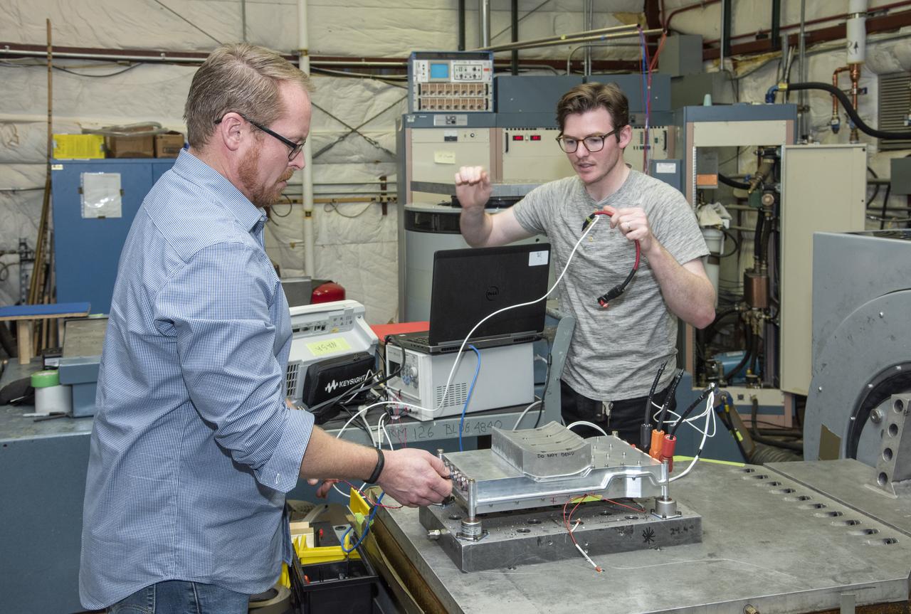Engineers from NASA's Armstrong Flight Research Center and Empirical Systems Aerospace prepare a cruise motor controller, planned to be used on NASA's all-electric X-57 Maxwell, for vibration testing at Armstrong's environmental lab. Testing the cruise motor controller at various vibration levels, based on baseline flight testing in the project's first phase, helps ensure that the hardware will withstand similar vibration in flight conditions. X-57, NASA's first all-electric experimental aircraft, or X-plane, will fly in its first all-electric configuration in 2020.