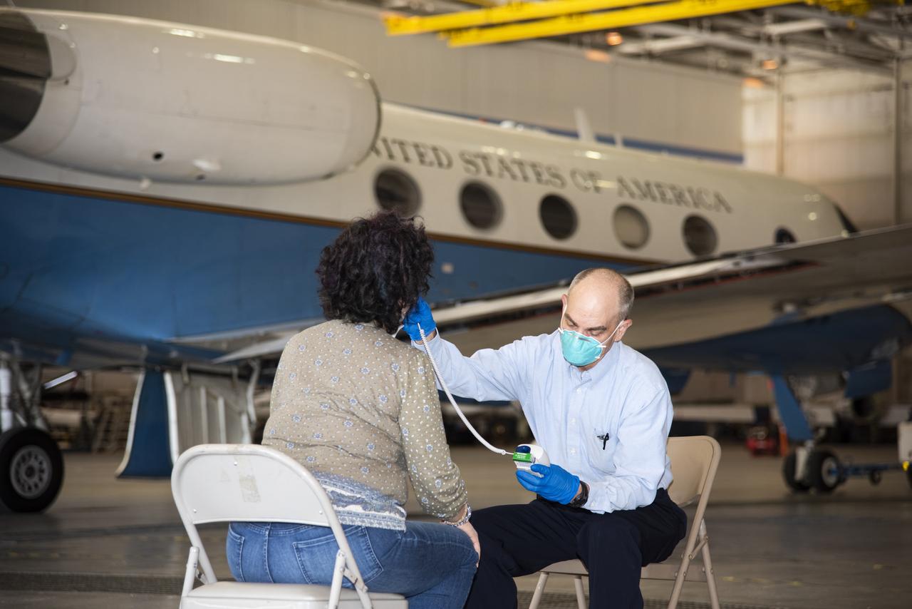 Dr. Dwight Peake, NASA’s Armstrong Flight Research Center chief medical officer and flight surgeon, confirms a NASA Jet Propulsion Laboratory (JPL) staff member is ready for flight. The two California NASA centers are working together to fly JPL staff on an Armstrong G-III aircraft from California to NASA’s Kennedy Space Center in Florida. JPL staff are completing critical work to ensure NASA’s Mars 2020 mission is ready on time.