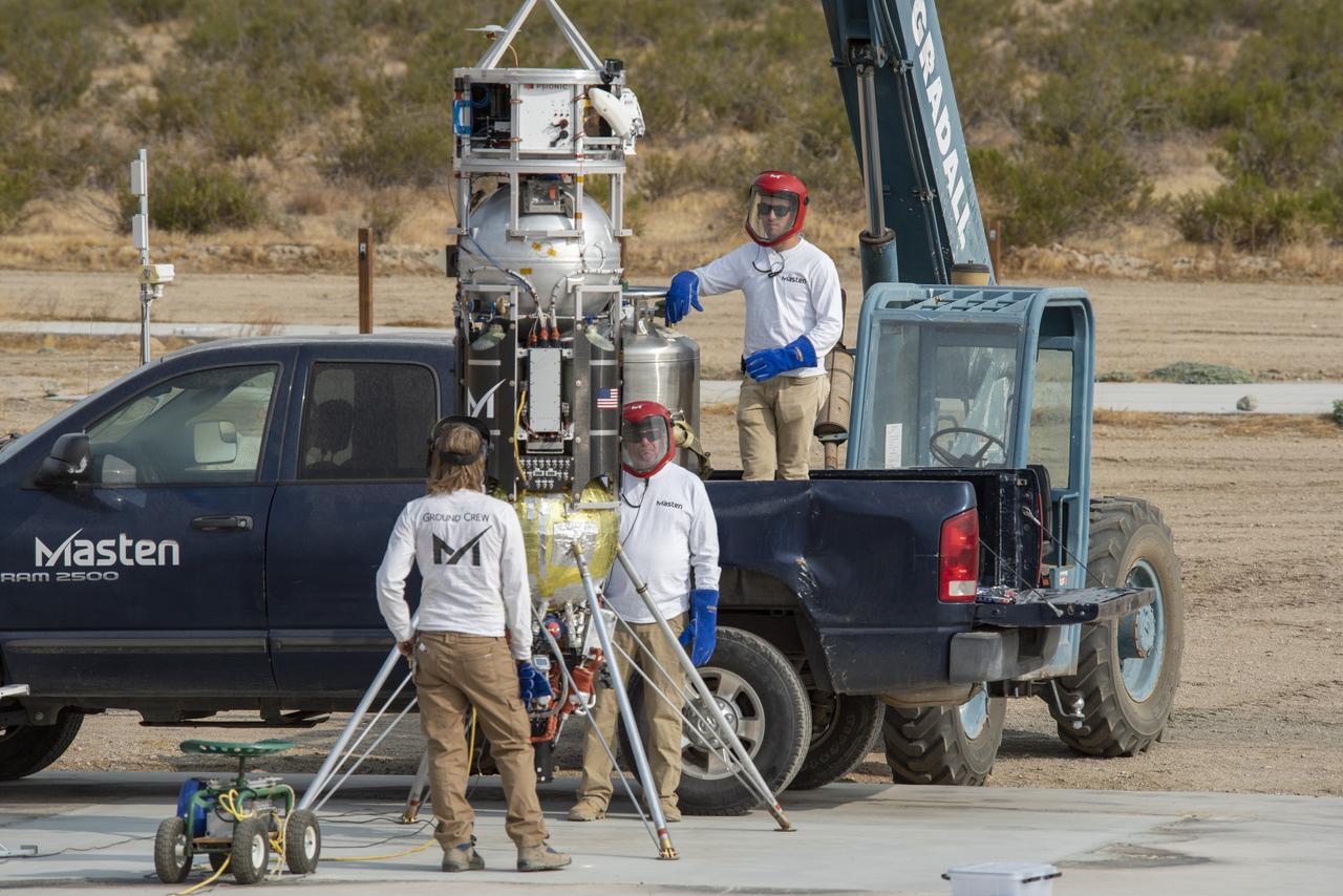 Masten Space Systems employees prepare its rocket to flight test NASA -licensed Psionic navigation doppler lidar technology that enables precision landing on celestial bodies where GPS for navigation only available on Earth is not an option.