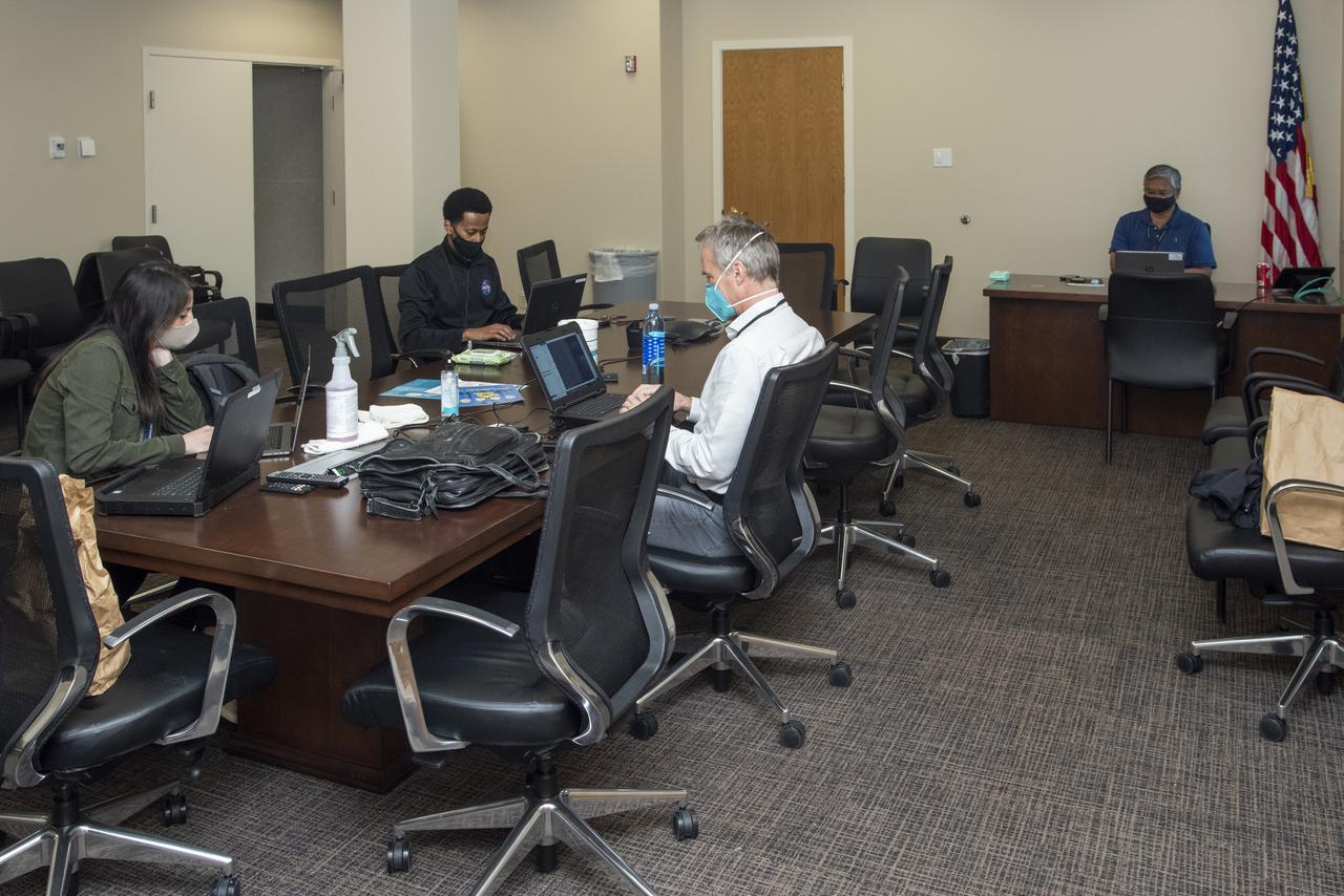 Ames Research Center researchers from left to right Yasmin Arbab, Â  Faisal OmarÂ and Mark Snycerski on the Advanced Air MobilityÂ National Campaign projectâ€™s Airspace Test Infrastructure (ATI) team as well as Armstrongâ€™s Sam Simpliciano in the background. The researchers monitor surveillance data from the helicopter in real time during the NC Integrated Dry Run TestÂ the first week of December 2020 at NASAâ€™s Armstrong Flight Research Center in California.