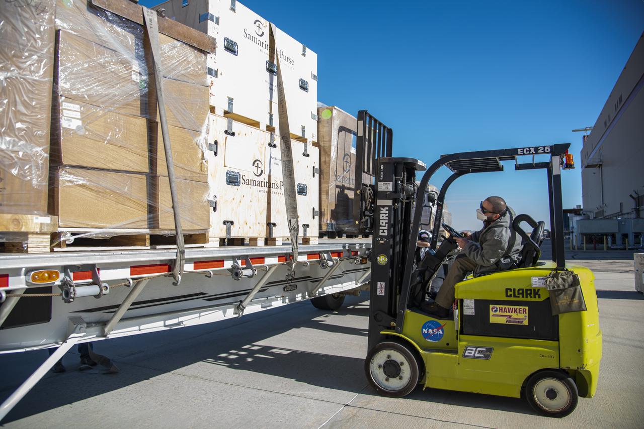 Marlon Espinoza uses a forklift at NASA's Armstrong Flight Research Center Building 703 in Palmdale, California, to assist in Samaritan Purse's COVID-19 aid work. The supplies were unloaded from a DC-8 and loaded onto a truck.