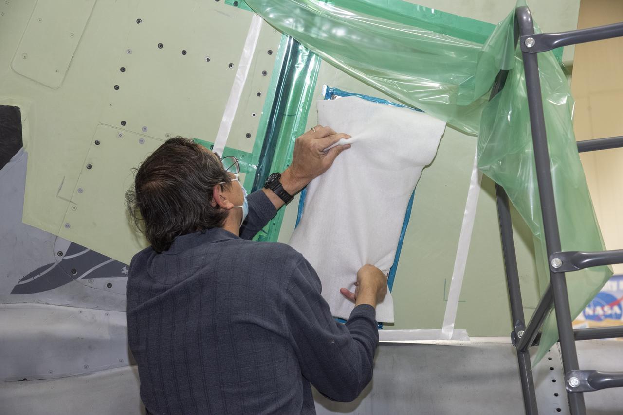 The load pad bonding process for the vertical tails was a preliminary step in the process to test the F/A-18E from the Naval Air Systems Command (NAVAIR) in Patuxent River, Maryland. The aircraft is in NASA’s Armstrong Flight Research Center Flight Loads Laboratory in Edwards, California, for the center’s biggest load calibrations tests. This testing is needed before the aircraft can serve as a test vehicle for determining if it can safely manage maneuvers and proposed upgrades. 