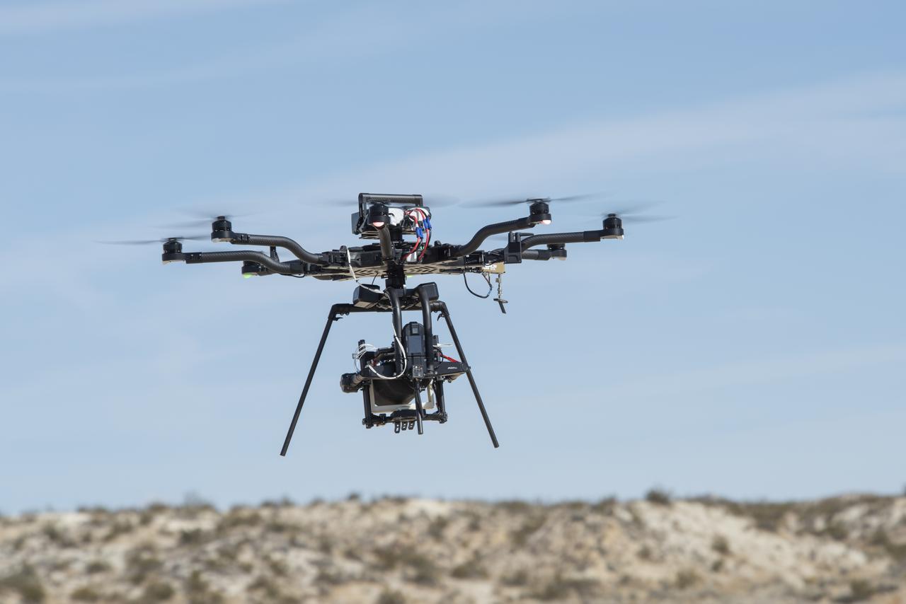 The Alta 8 remotely piloted aircraft hovers above Rosamond North Lakebed in March 2021 at NASA's Armstrong Flight Research Center in Edwards, California. The Resilient Autonomy project used these flights to collect data with the Nav Module hardware and software developed by NASA's Jet Propulsion Laboratory in Pasadena, California.