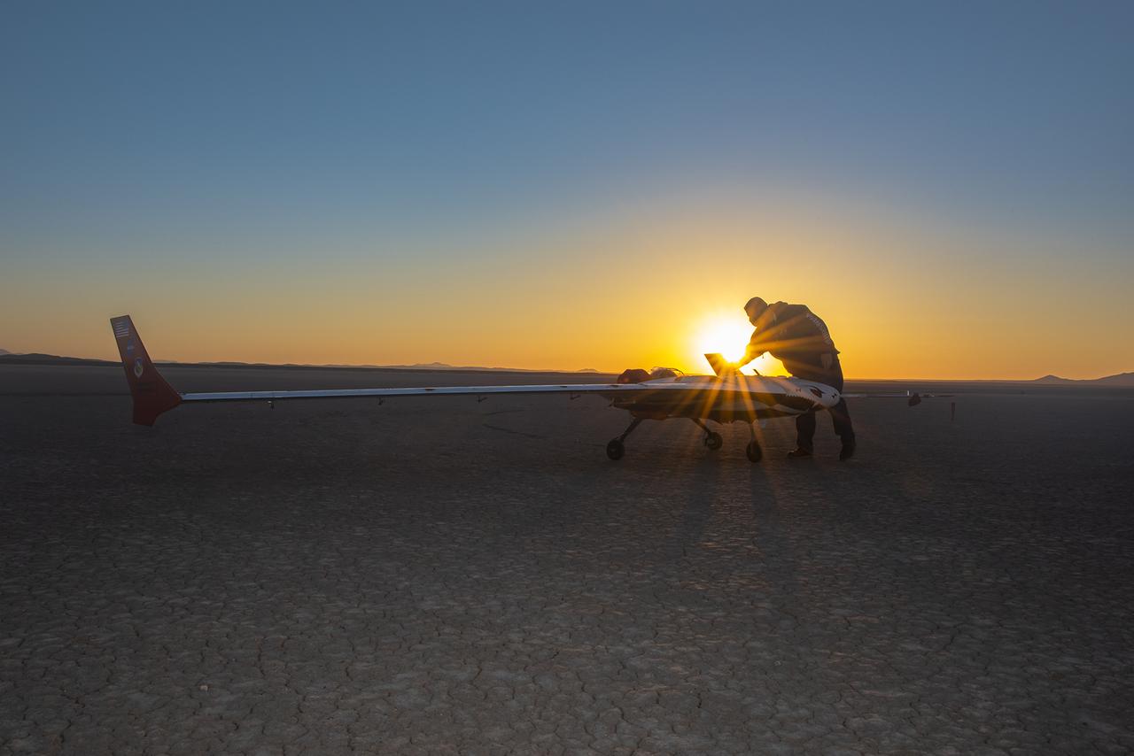 Preparations for the X-56B remotely piloted aircraft to begin a new flight series continue as the sun rises on Rogers Dry Lake. The flight was April 19 at NASA's Armstrong Flight Research Center in Edwards, California, with partner Northrop Grumman.