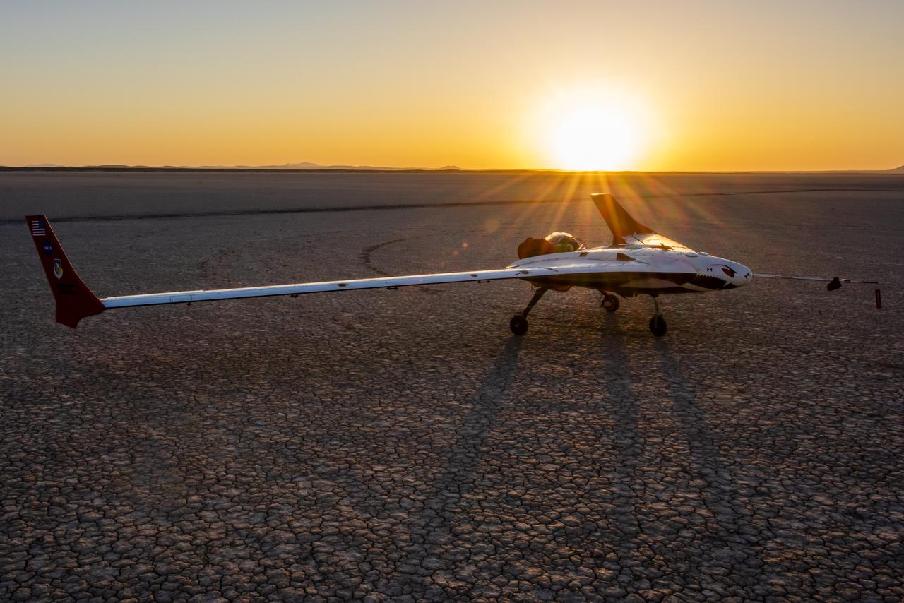 Preparations for the X-56B remotely piloted aircraft to begin a new flight series continue as the sun rises on Rogers Dry Lake. The flight was April 19 at NASA's Armstrong Flight Research Center in Edwards, California, with partner Northrop Grumman.