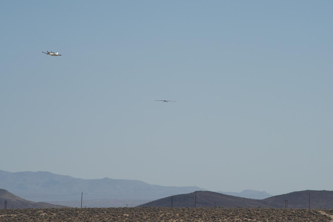 The X-56B remotely piloted aircraft flies the first of a new flight series, as a T-34 observes. The flight was April 19 at NASA's Armstrong Flight Research Center in Edwards, California, with partner Northrop Grumman.