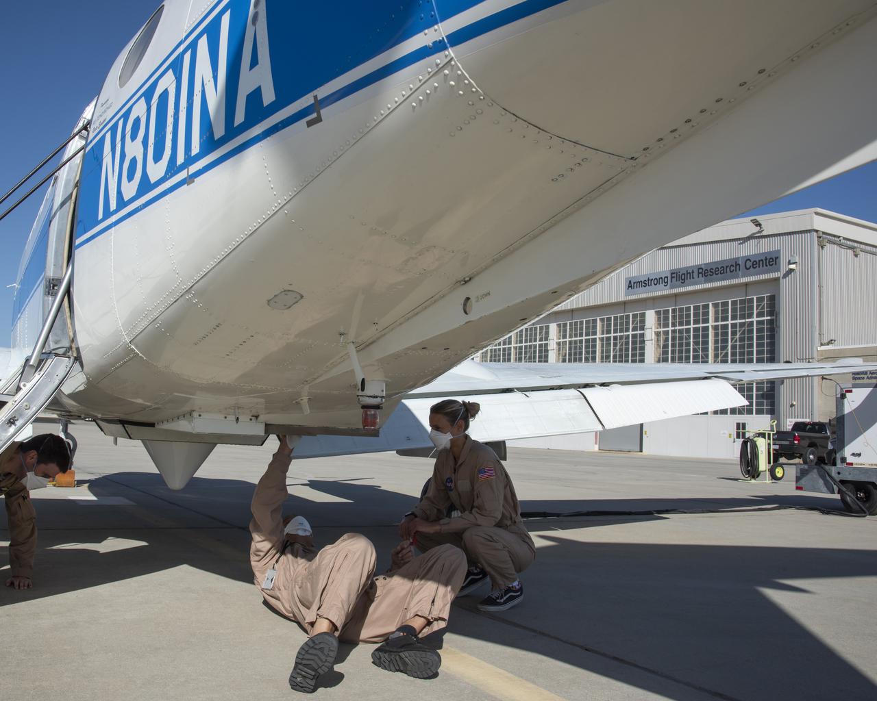 A flight crew prepares for the B200 King Air Sub-Mesoscale Ocean Dynamics Experiment (S-MODE) at NASA's Armstrong Flight Research Center in Edwards, California. From left to right are Scott "Jelly" Howe, Jeroen Molemaker and Delphine Hypolite.
