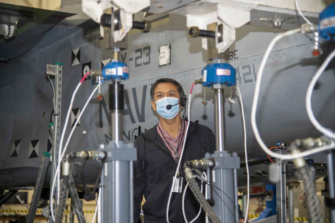 Larry Hudson does an inspection after the actuator on the F/A-18E from the Naval Air Systems Command (NAVAIR) in Patuxent River, Maryland, is pinned to the horizontal tail load test fixture. The aircraft is in NASA’s Armstrong Flight Research Center Flight Loads Laboratory in Edwards, California, for the center’s biggest load calibrations tests. This testing is needed before the aircraft can serve as a test vehicle for determining if it can safely manage maneuvers and proposed upgrades.