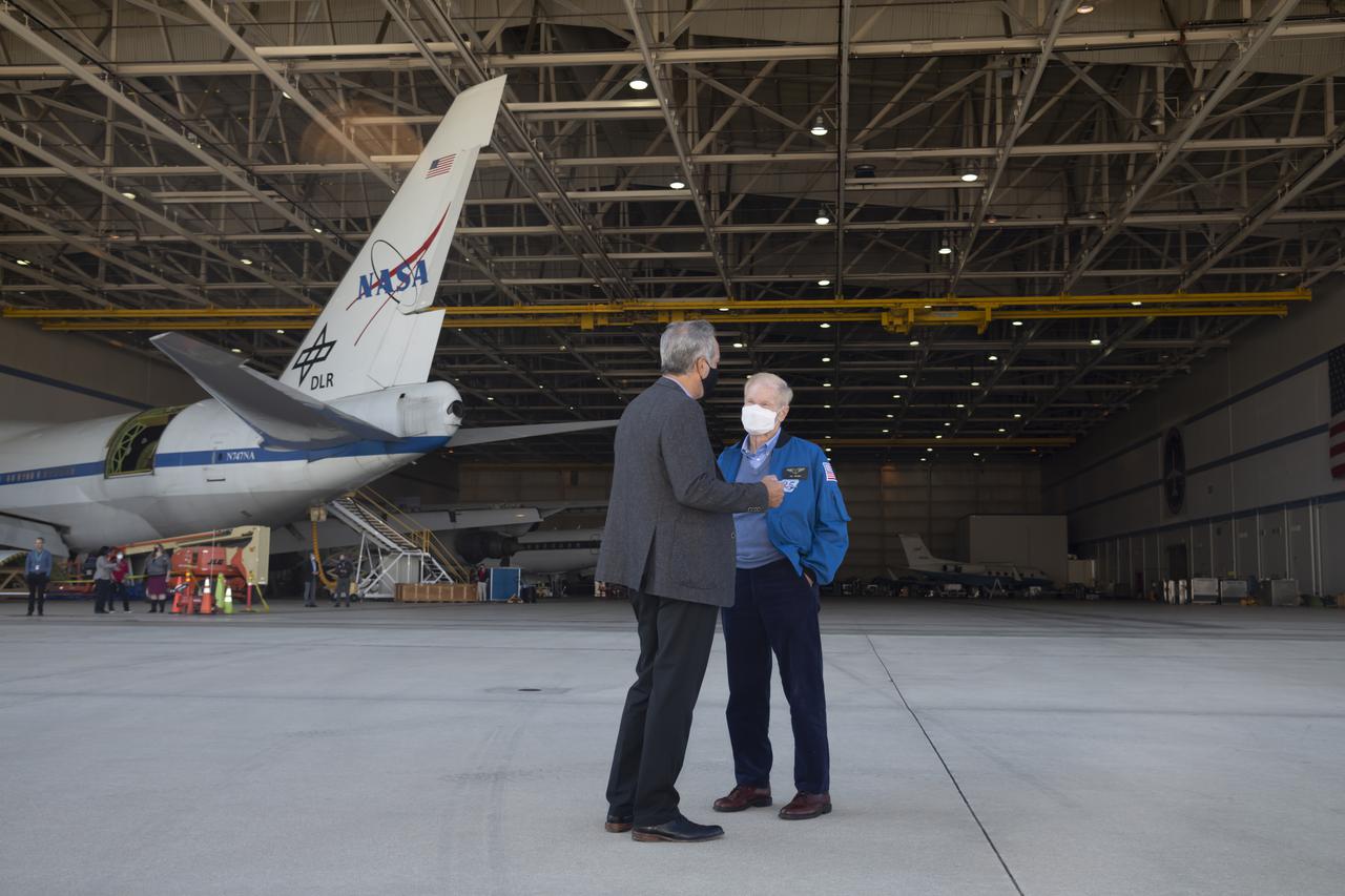 NASA Administrator Bill Nelson, right, and David McBride, center director at NASA’s Armstrong Flight Research Center in Edwards, California, talk by the Stratospheric Observatory for Infrared Science during the administrator’s visit to NASA Armstrong’s Building 703 in Palmdale, California, on Oct. 12.