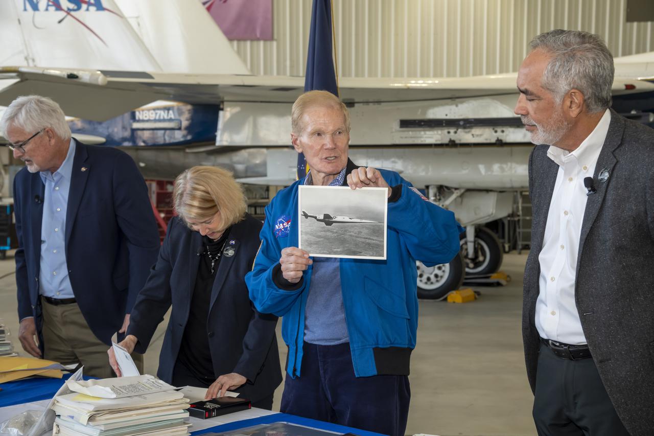 NASA Administrator Bill Nelson shows a picture of the X-3 to NASA Armstrong Flight Research Center Director David McBride on Oct. 13. NASA Armstrong Deputy Center Director Patrick Stoliker and NASA Deputy Administrator Pam Melroy also are with Nelson and McBride. The photo was contained in a time capsule that was sealed on the center's 50th anniversary and opened to commemorate its 75th anniversary. NASA Armstrong is in Edwards, California.