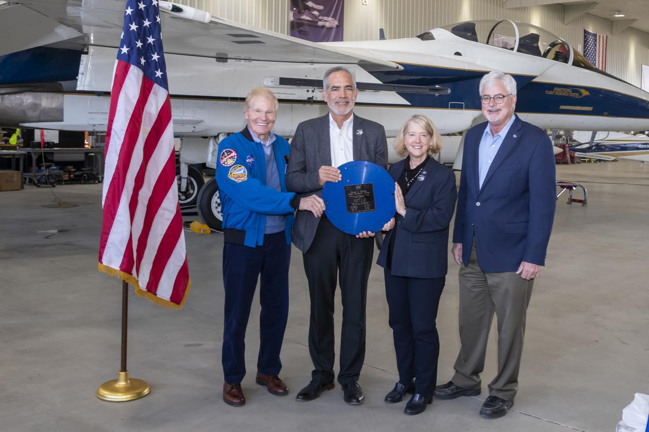 NASA Administrator Bill Nelson, from left, NASA Armstrong Flight Research Center Director David McBride, NASA Deputy Administrator Pam Melroy, and NASA Armstrong Deputy Center Director Patrick Stoliker, display the lid to a time capsule on Oct. 13. The time capsule was sealed on the center's 50th anniversary and opened to commemorate its 75th anniversary. NASA Armstrong is in Edwards, California.