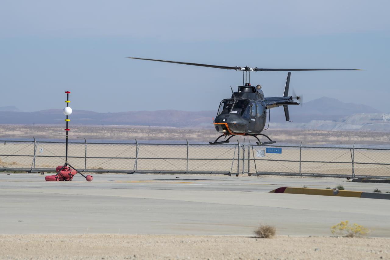 Flight Research Inc.'s Bell OH-58 Kiowa helicopter flies around a visual aid, known as a tetherball, created to serve as the pilot's visual height reference while performing handling qualities testing at NASA's Armstrong Flight Research Center in Edwards, California, Nov. 8-10. NASA's Advanced Air Mobility National Campaign used the helicopter to study urban air mobility vehicle and airspace requirements.