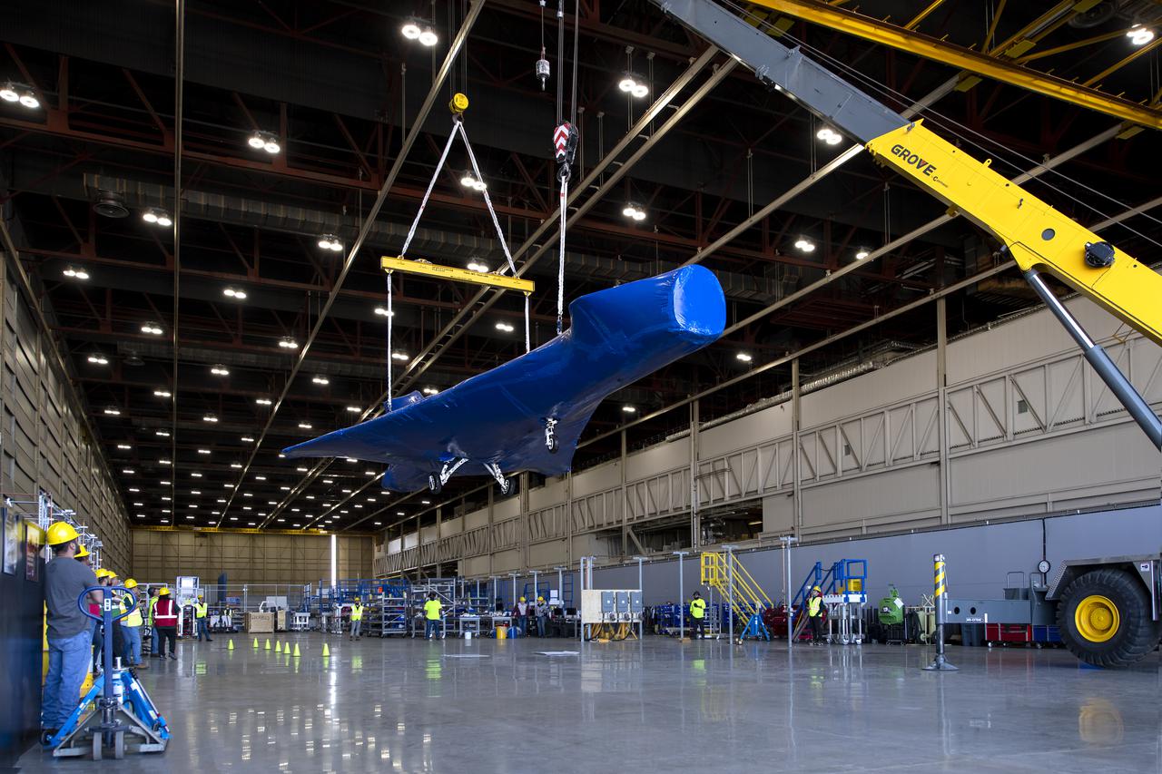 The X-59, NASA’s quiet supersonic technology experimental aircraft, is suspended in the air at Lockheed Martin’s Skunk Works facility in Palmdale, California, following several months of critical ground testing in Ft. Worth, Texas