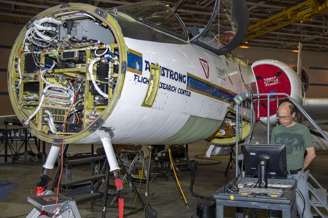 NASA's ER-2 aircraft is prepared for a check flight by Eric Hintsa, scientist of the Unmanned Aircraft Systems (UAS) Chromatograph for Atmospheric Trace Species (UCATS) instrument, on May 13, 2022.
