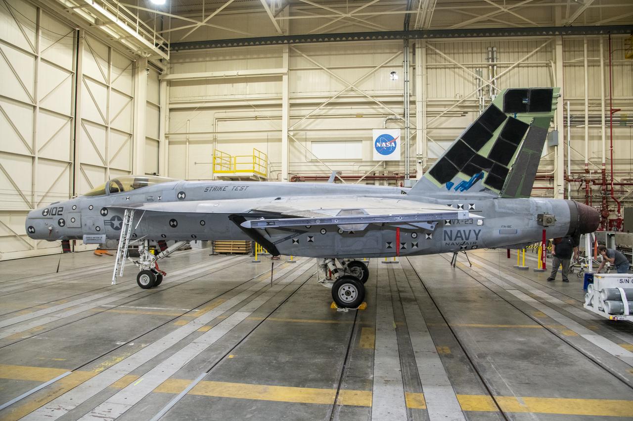 This right-side view shows an F/A-18E from the Naval Air Systems Command (NAVAIR) in Patuxent River, Maryland. The aircraft is in NASAâ€™s Armstrong Flight Research Center Flight Loads Laboratory in Edwards, California, where it underwent the centerâ€™s biggest load calibrations tests. This testing will permit the aircraft to serve as a test vehicle to determine if it can safely manage maneuvers and proposed upgrades.