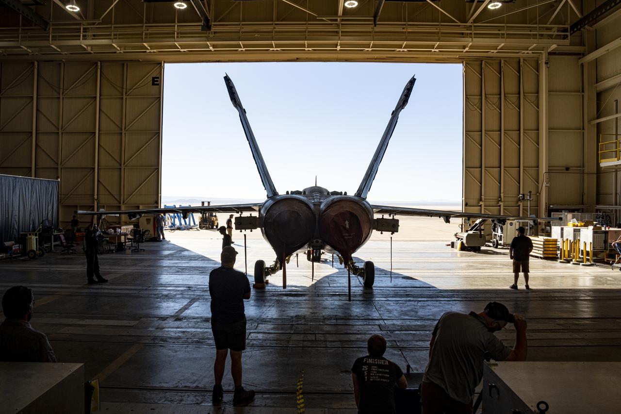 This rear view shows an F/A-18E from the Naval Air Systems Command (NAVAIR) in Patuxent River, Maryland. The aircraft is in NASAâ€™s Armstrong Flight Research Center Flight Loads Laboratory in Edwards, California, where it underwent the centerâ€™s biggest load calibrations tests. This testing will permit the aircraft to serve as a test vehicle to determine if it can safely manage maneuvers and proposed upgrades.