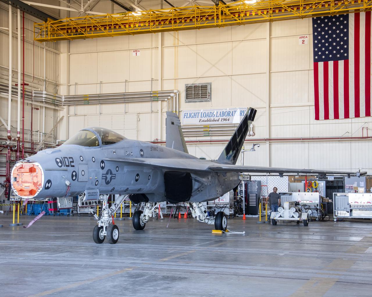 This front view shows an F/A-18E from the Naval Air Systems Command (NAVAIR) in Patuxent River, Maryland. The aircraft is in NASAâ€™s Armstrong Flight Research Center Flight Loads Laboratory in Edwards, California, where it underwent the centerâ€™s biggest load calibrations tests. This testing will permit the aircraft to serve as a test vehicle to determine if it can safely manage maneuvers and proposed upgrades.