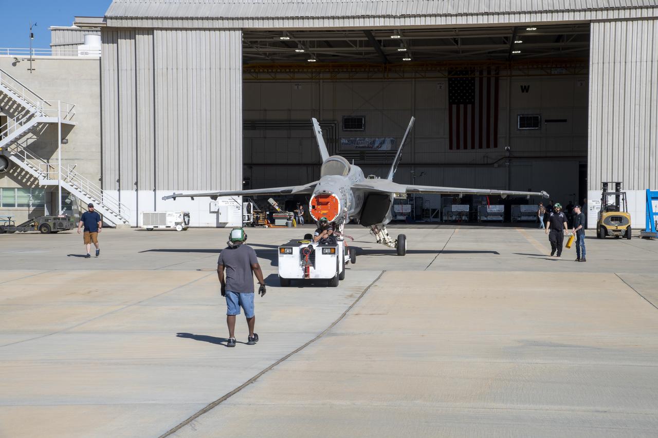 An F/A-18E from the Naval Air Systems Command (NAVAIR) in Patuxent River, Maryland, is moved from NASAâ€™s Armstrong Flight Research Center Flight Loads Laboratory in Edwards, California, to a hangar where it will undergo final preparations to return to its squadron. The aircraft underwent the centerâ€™s biggest load calibrations tests. The testing will permit the aircraft to serve as a test vehicle to determine if it can safely manage maneuvers and proposed upgrades.