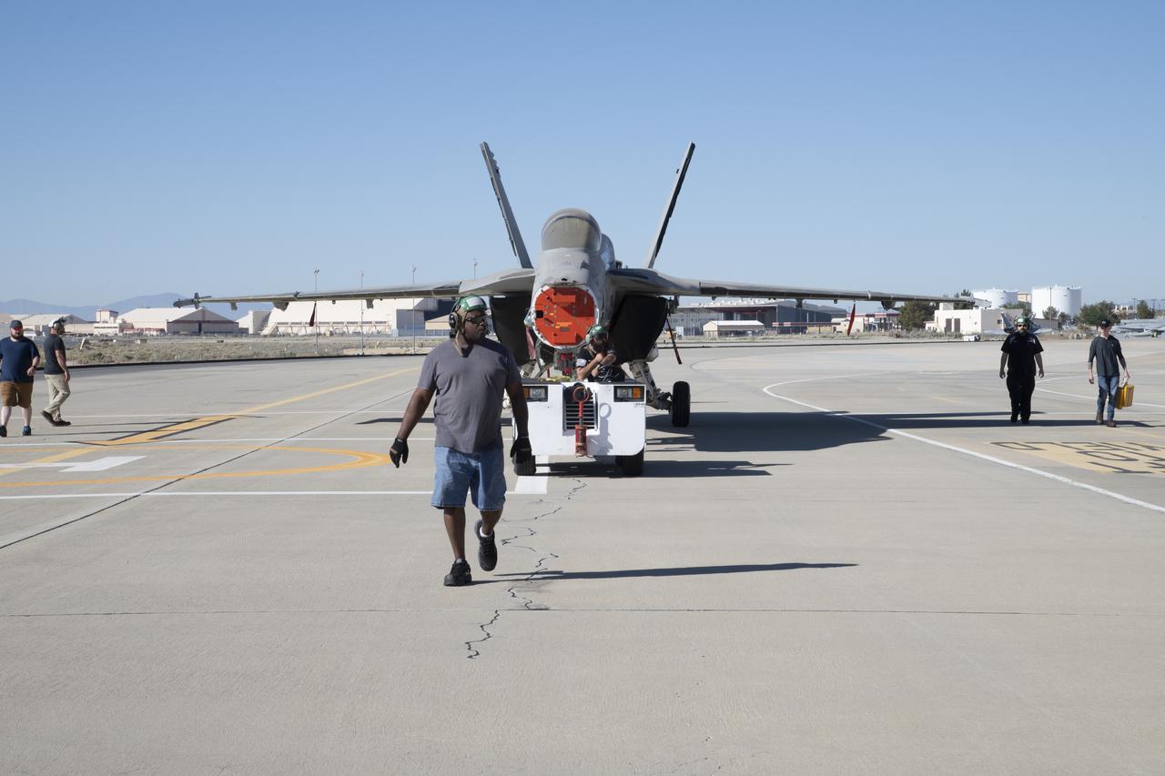 An F/A-18E from the Naval Air Systems Command (NAVAIR) in Patuxent River, Maryland, is moved from NASAâ€™s Armstrong Flight Research Center Flight Loads Laboratory in Edwards, California, to a hangar where it will undergo final preparations to return to its squadron. The aircraft underwent the centerâ€™s biggest load calibrations tests. The testing will permit the aircraft to serve as a test vehicle to determine if it can safely manage maneuvers and proposed upgrades.