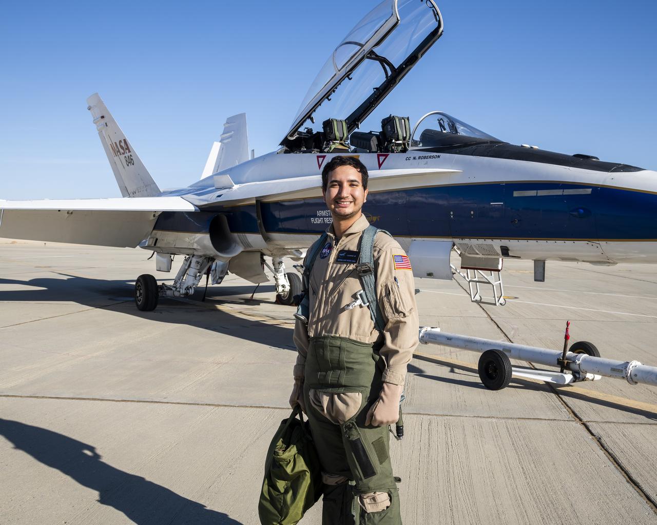 Julio Treviño, lead operations engineer for NASA’s Global Hawk SkyRange project, stands in front of an F/A-18 mission support aircraft at NASA’s Armstrong Flight Research Center in Edwards, California.