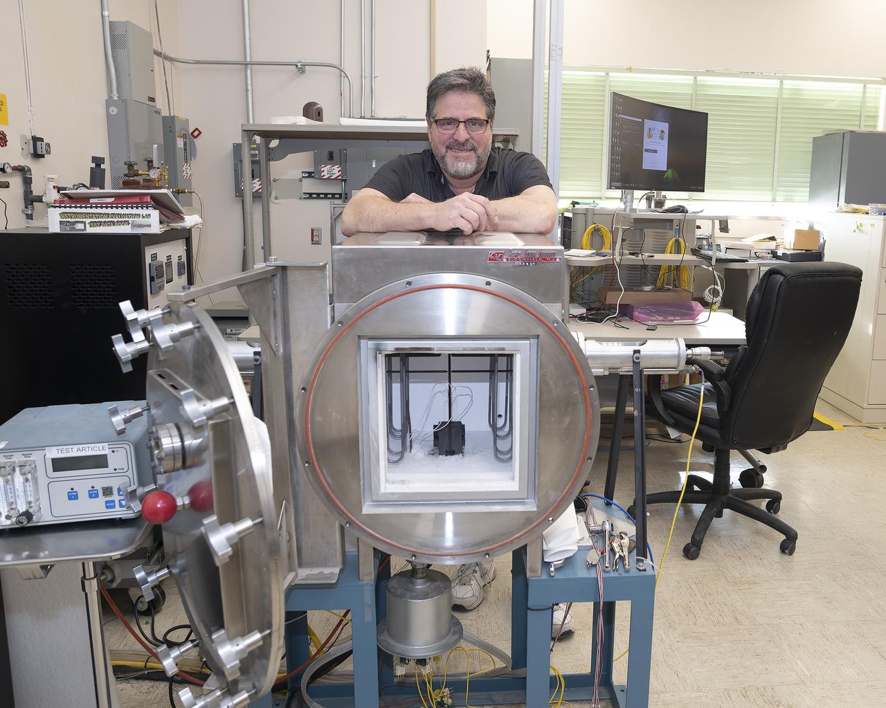 Anthony piazza, a researcher at NASA’s Armstrong Flight Research center in Edwards, California, works with high-temperature strain sensors. This test article is a bending load bar, which enables high-temperature optical strain sensor research up to 1,800 degrees Fahrenheit.