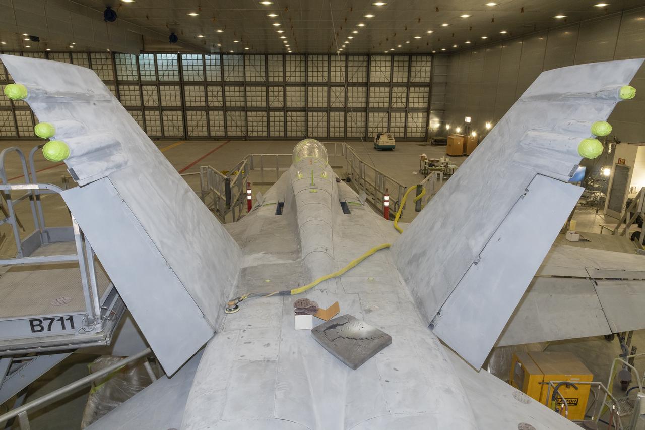 This view of NASA 862, which is an F/A-18D based at NASA’s Armstrong Flight Research Center in Edwards, California, shows the sanding work is about complete at the U.S. Air Force Corrosion Control Facility. The facility is located on Edwards Air Force Base and is also known as the Paint Barn. 