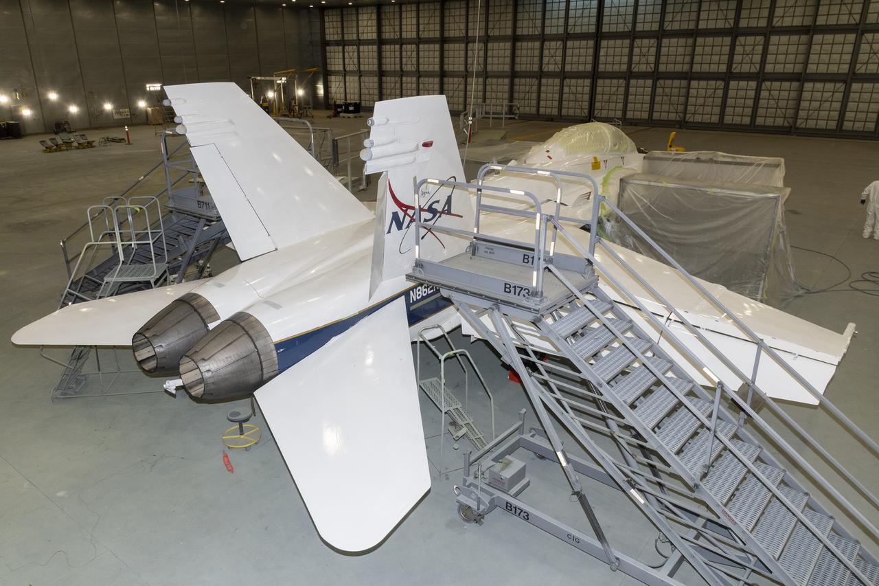 U.S. Air Force Corrosion Control Facility nears the end of stencils and painting of NASA 862, which is an F/A-18D based at NASA’s Armstrong Flight Research Center in Edwards, California. The corrosion control facility is located on Edwards Air Force Base and is also known as the Paint Barn. 