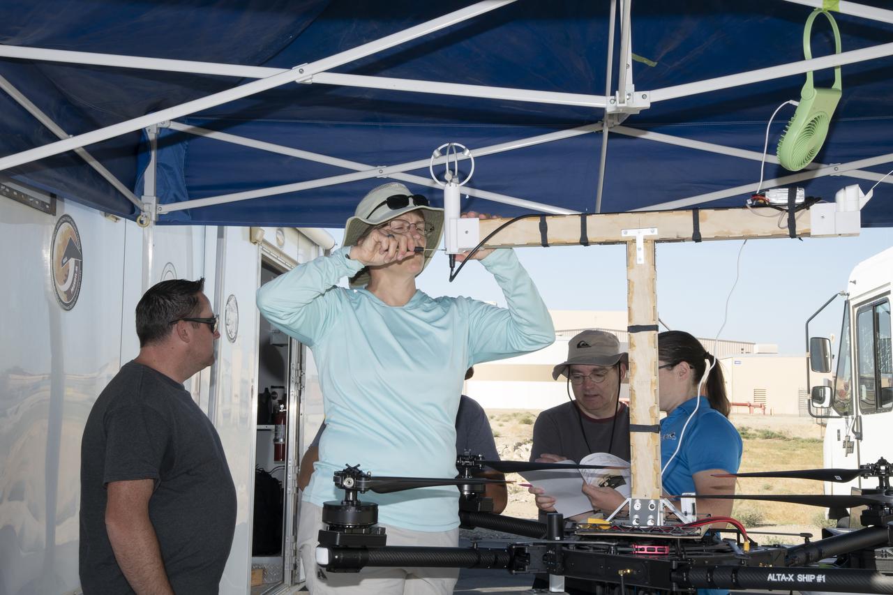 Jennifer Fowler works on securing sensors onto the test fixture on the Alta-X aircraft. Justin Link, Grady Koch, and Tyler Willhite are in the background. The Advanced Exploration of Reliable Operation at Low Altitudes: Meteorology, Simulation and Technology campaign was at NASA’s Armstrong Flight Research Center in Edwards, California. The focus was to study wind from the ground to 2,000 feet to provide data to assist future drones to safely land on rooftop hubs called vertiports and to potentially improve weather prediction.